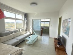 乳山银滩长江路年租6600 供暖小区 电梯十楼看海看山 两室 有网有空调出租房源真实图片